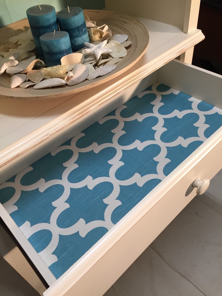 Beach style bookcase makeover with lined drawer for color pop